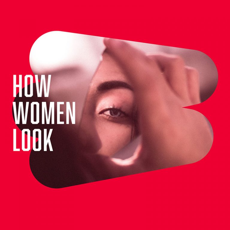 Woman looking at her reflection in a broken mirror with the words "How Women Look" next to the image